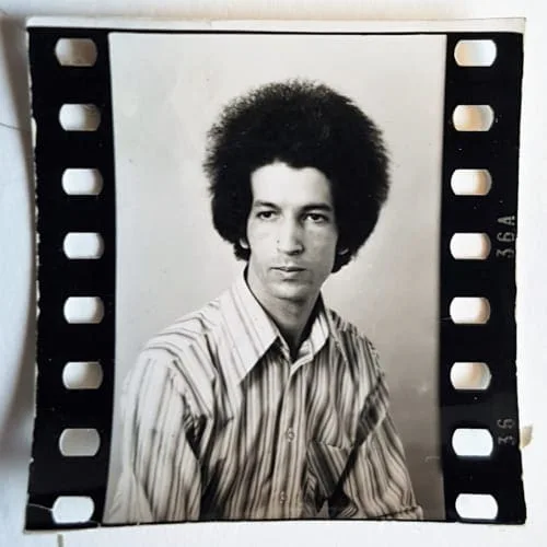 El Arbi Bouqdib in the early 1970s: portrait of a young man in a striped shirt, on a film strip, black and white
