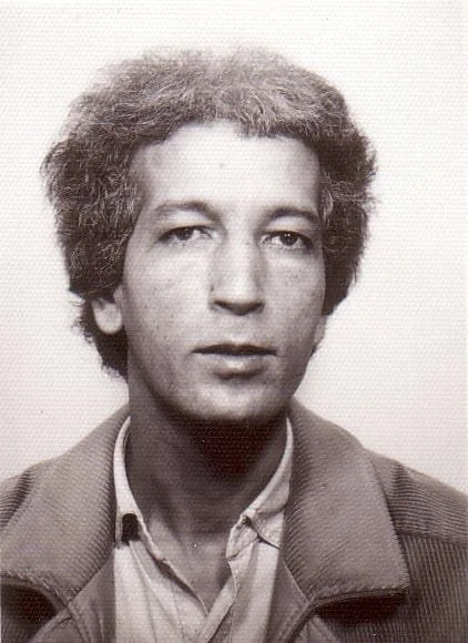 Black-and-white portrait of the young El Arbi Bouqdib with curly hair