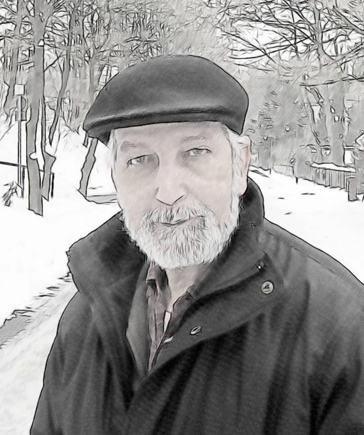 The older El Arbi Bouqdib in a flat cap and beard in a snowy park, black and white